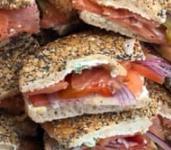 Lox Wedge · Flagel with sliced lox, scallion cream cheese, tomatoes, onions, and jalapenos,
