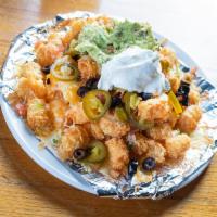 Totchos · Tator tots topped with melted cheese, black olives, jalapenos, pico de gallo and sour cream.