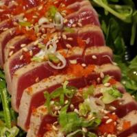 Tuna Tataki · 7 pieces. Raw. Seared white tuna, topped with scallions and tobiko. Served with ponzu sauce.