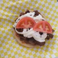 Gyro · Sliced Gyro Meat served on a Pita & Topped with Tzatziki, tomatoes and onions.