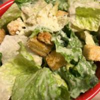 Side Caesar Salad · A mix of green leaf and romaine lettuce, parmesan and house made croutons tossed in Caesar d...