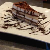 Tiramisu · Espresso drenched cake, layered with mascarpone cheese mousse, sprinkled with cocoa sugar.
