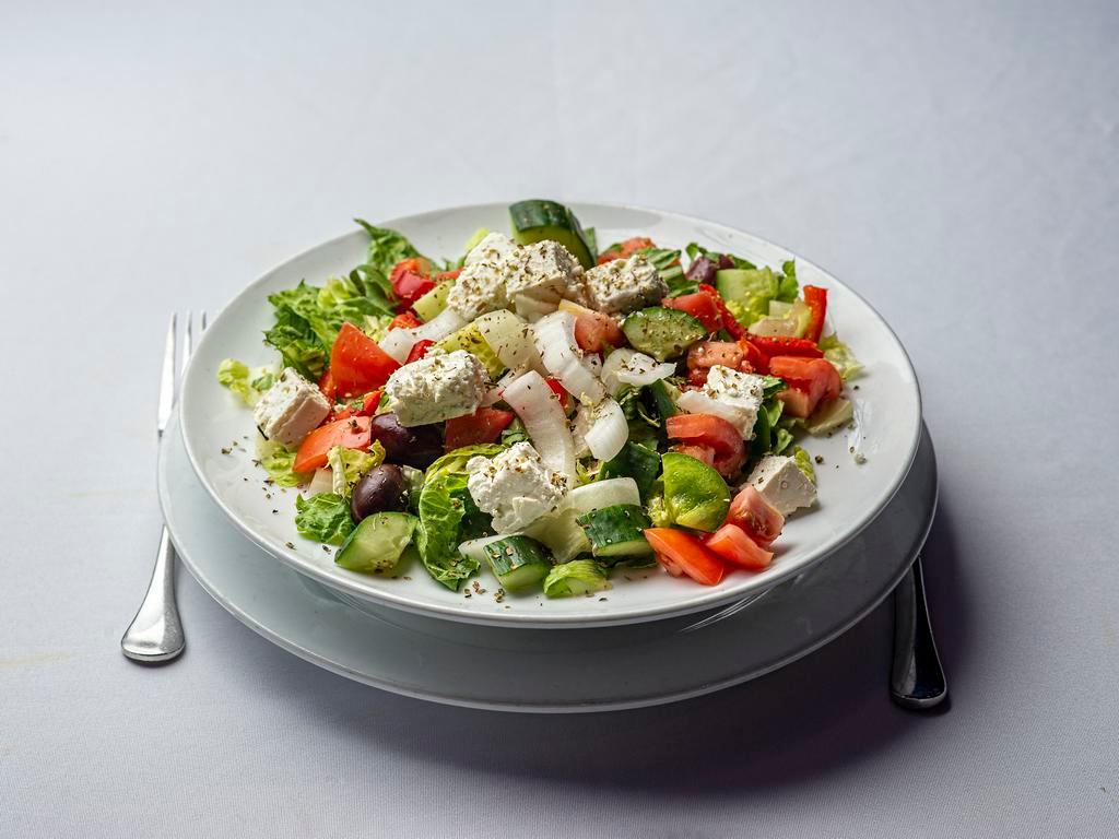 Greek Salad · Romaine, tomatoes, cucumbers, bell peppers, Kalamata olives, onions, feta, extra-virgin olive oil, mint vinaigrette.