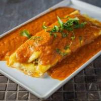 Floating Omelette · Cheese stuffed omelet topped with tomato-based gravy.