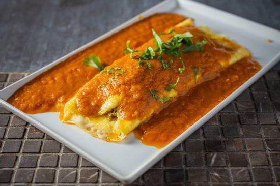 Floating Omelette · Cheese stuffed omelet topped with tomato-based gravy.