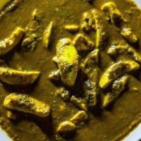 Green Egg Curry · Pieces of boiled egg cooked in mint gravy.