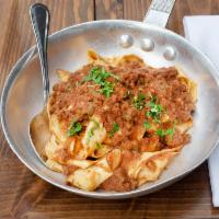 Pappardelle alla Bolognese · Homemade ribbon pasta and meat sauce.