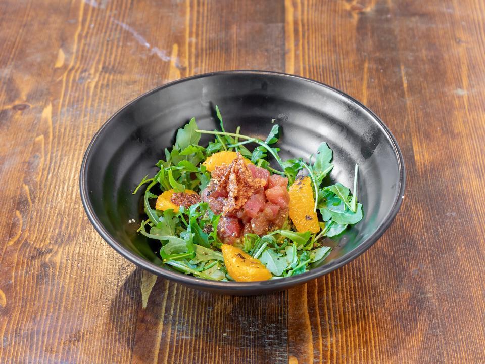 Tuna Tartar Salad · Marinated tuna, arugula, oranges, crispy rice chips and GLUTEN FREE