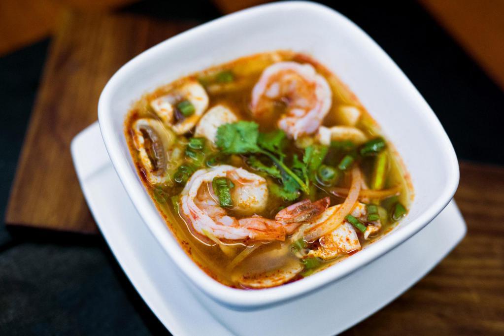 Tom Yum Soup · Spicy lemongrass shrimp broth with fresh mushrooms, onion, tomato, scallion, cilantro and lime. Medium spicy.