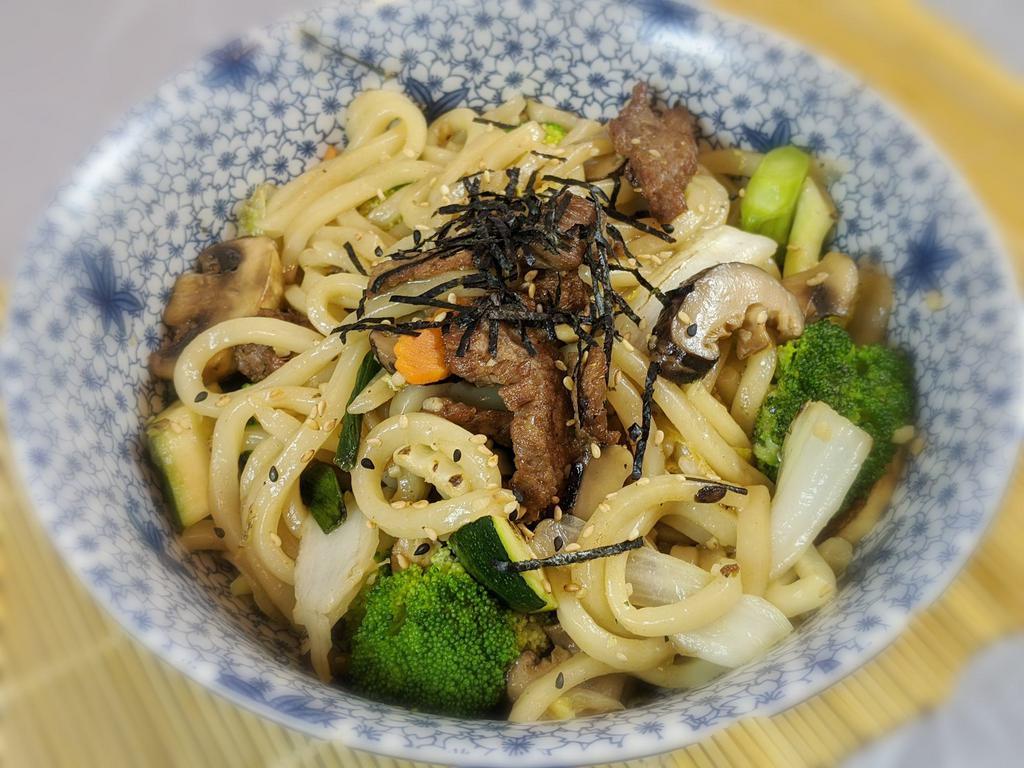 Yaki Udon Noodle · Stir fried thick udon noodles with cabbage, carrots, broccoli and mushrooms in a sesame soy sauce.