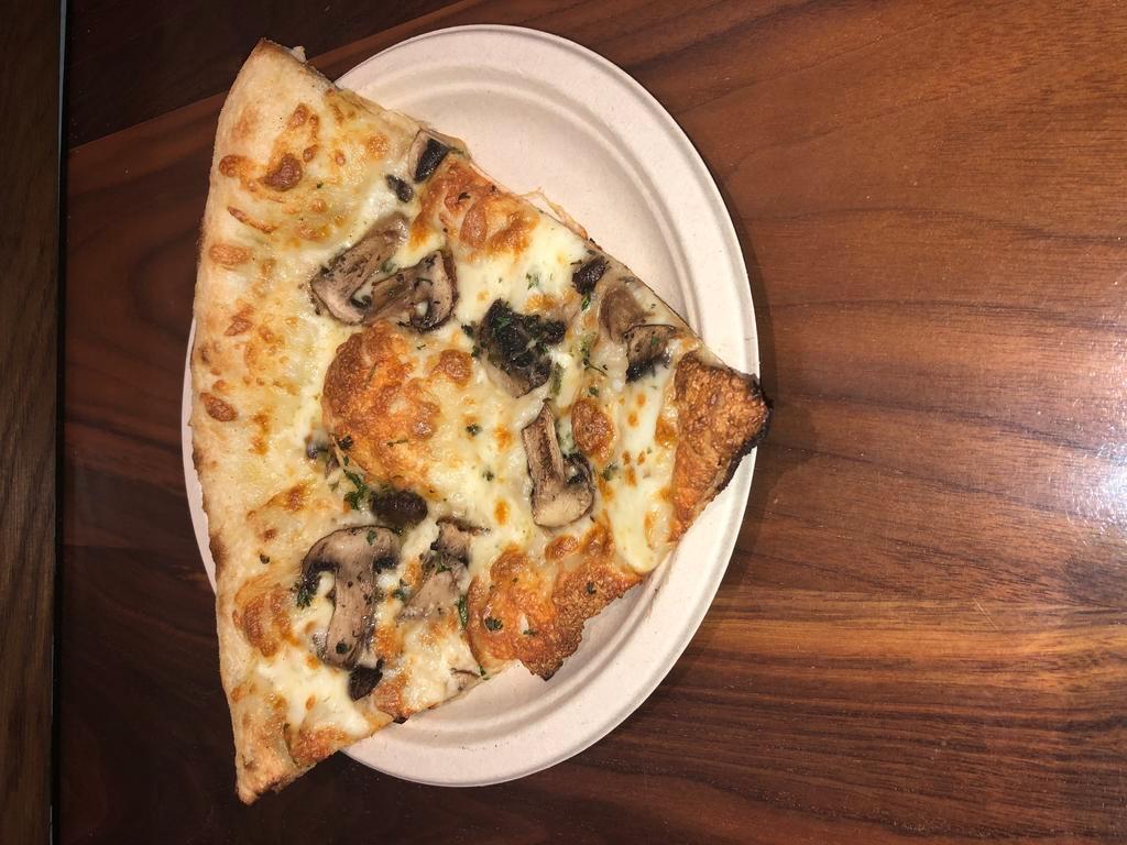 The Shroom Pizza Slice · Cremini and oyster mushrooms, fresh oregano, truffle oil, mozzarella and garlic oil.