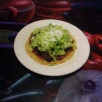 Sopes de Bistec · Corn based tortilla topped off with beans, steak, lettuce, and cheese
