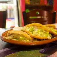 Gordita · Corn based dough filled with steak, lettuce, and cheese