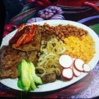 Bistec Encebollado · Dos bistek asados con cebolla, arroz y frijoles/
Two roasted steaks with onion, rice and beans