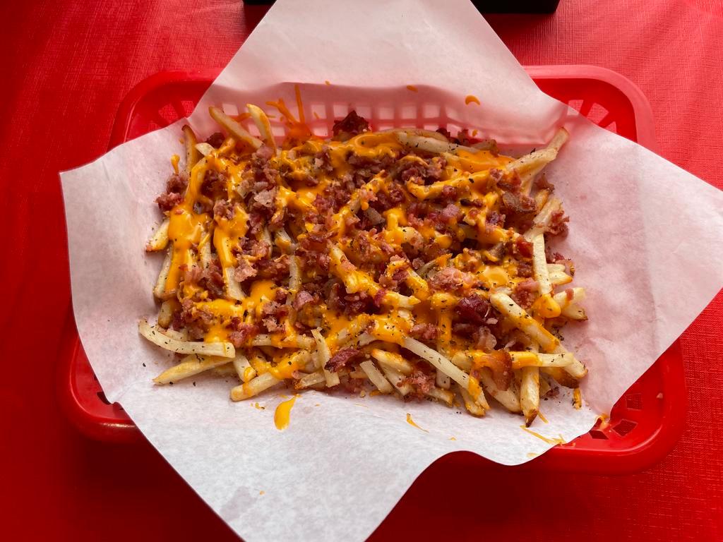 Bacon Cheddar Fries · A generous portion of our Garlic Fries smothered in cheddar cheese sauce and topped with bacon.