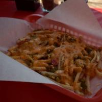 Green Chile Cheese Fries · Our Garlic Parm Fries topped with Green Chile and Cheddar Cheese Sauce