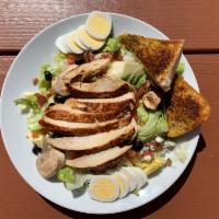 Cobb Salad · Chicken, olives, bacon, blue cheese, mushrooms, onions, tomatoes served with garlic bread an...