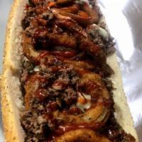 Texas Hold'em Cheese Steak · Beef or chicken topped with BBQ sauce, and onion rings.