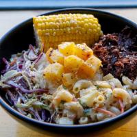 Kalua Pork Dinner · Pork slow roasted in banana leaves and spices, with Rice, Mac salad, and Coleslaw
