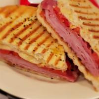 Hot Italian Panini Lunch · Ham, salami, tomato, roasted red peppers, melted provolone and Dijon mustard. Served with ch...