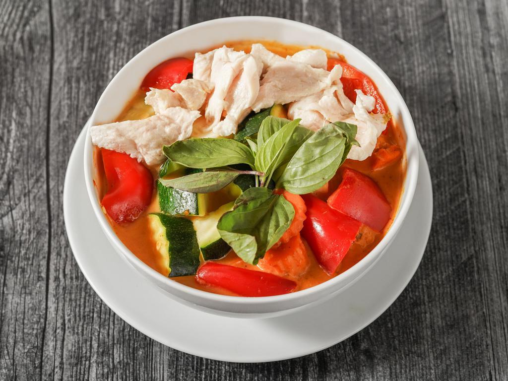 Chicken red curry 24oz · Spicy curry with chicken, bell pepper, carrots, zukini and bassil. Served with steam rice