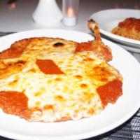 Pollo alla Parmigiana · Breast of chicken coated with bread crumbs, sauteed and topped with our tomato sauce and moz...