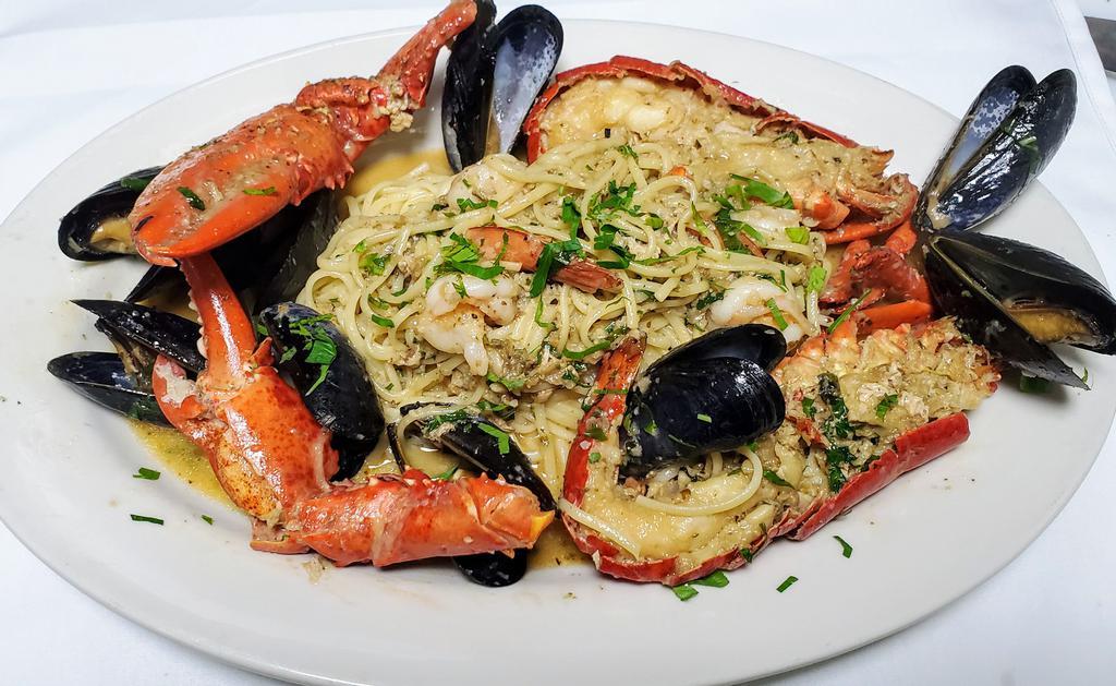 Lobster Seafood pasta · Whole Lobster seafood pasta, With Shirmp, Mussels and scallops in a white wine garlic and shallots sauce.