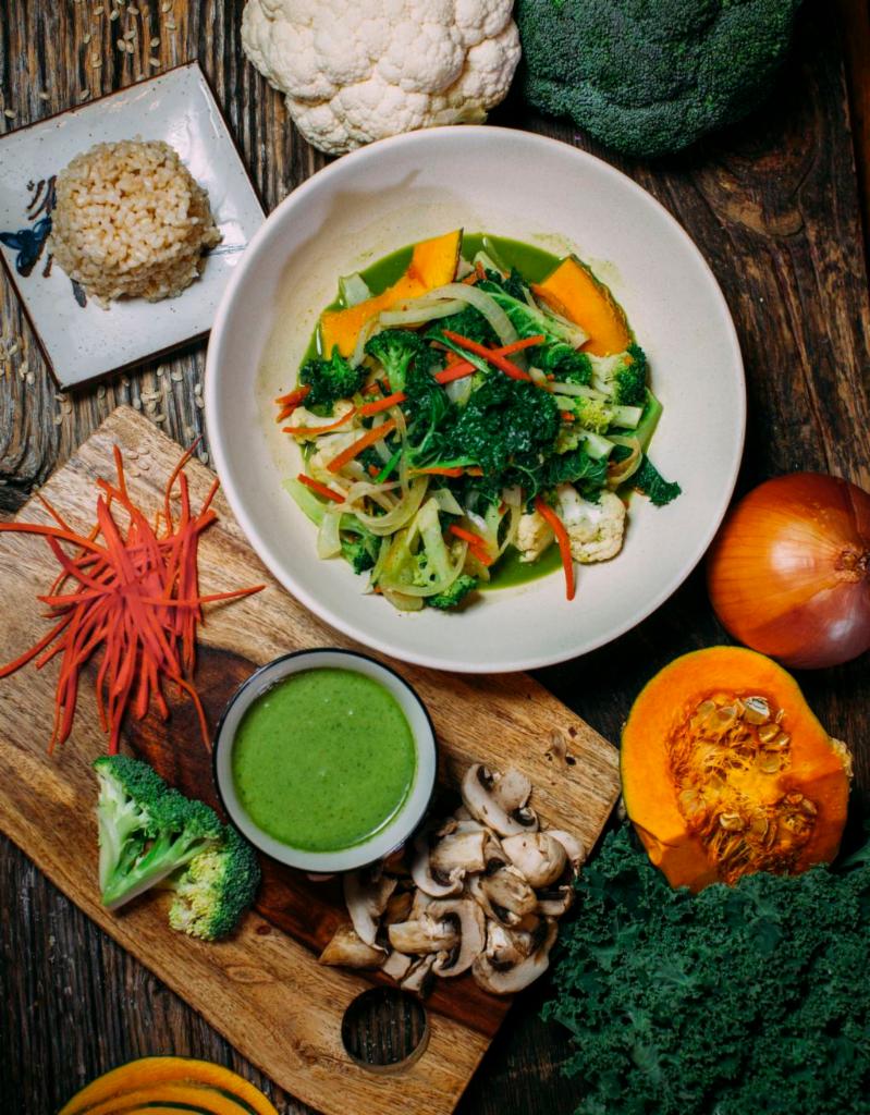 Green Curry Bowl · Sauteed kabocha, cauliflower, broccoli, white mushrooms, onions, carrot and kale in a home made coconut green curry. Comes with a side of brown rice.