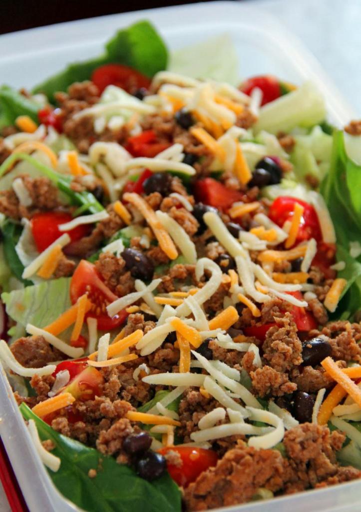 Taco Salad · Romaine lettuce, seasoned ground beef, cheese, tomato, onions, black olives, salsa, sour cream. *chips upon request