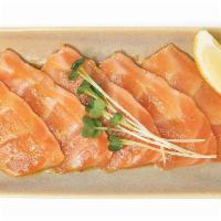 Salmon Carpaccio · Sliced salmon marinated in basil oil