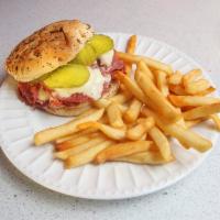 Corned Beef Sandwich · 7 oz. thinly sliced corned beef, pickles, mustard and cheese on an onion roll.