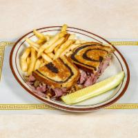 ​Grilled Ruben Sandwich · Corned beef, sauerkraut, and melted Swiss cheese nestled between two grilled slices of pumpe...