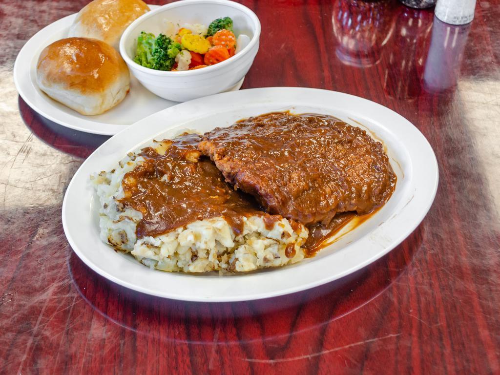 Chicken Fried Steak · Premium Angus beefsteak, battered, and deep-fried to perfection. Served topped with Homemade mashed potatoes, brown or white gravy, seasonal vegetables, and a fresh roll.