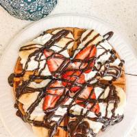 96. Strawberry Banana Waffle · Waffle topped with strawberry, banana, choice of syrup, and whipped cream.