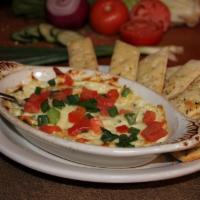 Artichoke Dip · Extra creamy dip is brick fried and served hot with artichoke hearts, roasted garlic, spinac...