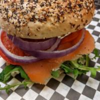 Smoked Salmon Bagel · Smoked Salmon, Cream Cheese, Red Onion, Arugula, Capers and Tomato on a plain or everything ...