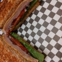 California Club Sandwich · Smoked turkey, avocado, bacon, lettuce, tomato, red onion, pepper jack cheese, and mayo on t...