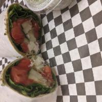 Veggie Wrap · Homemade hummus, spinach, tomato, red onion, avocados, cucumbers and feta cheese in a spinac...