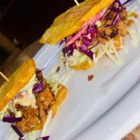 PATACONCITO · Crispy chicken fried plantain sandwich . Comes with mozarella cheese, cabbage, pickled onion...