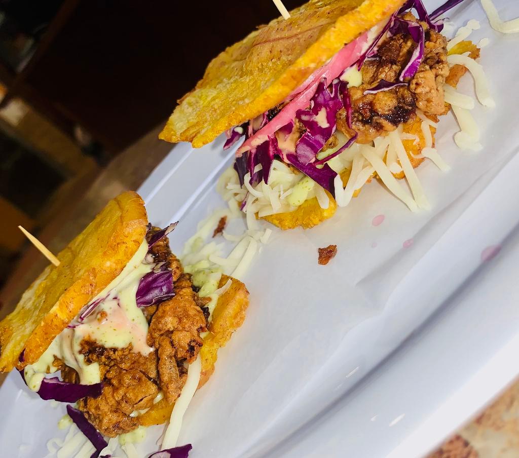 PATACONCITO · Crispy chicken fried plantain sandwich . Comes with mozarella cheese, cabbage, pickled onion , our signature pink and garlic sauce. Order comes with 2. 