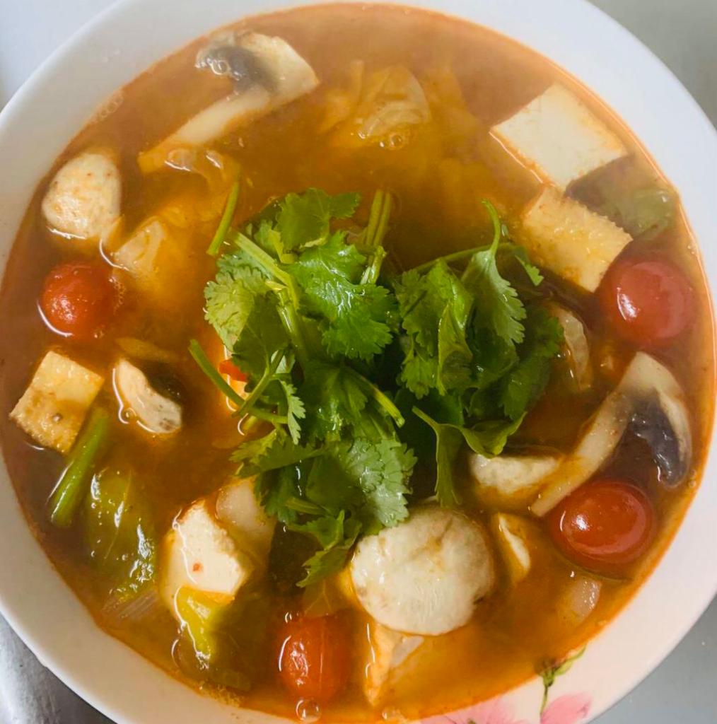 5. Tom Yum · Spicy and sour lemon grass soup with galangal, kaffir lime leaves, tomato, onion, and mushrooms.