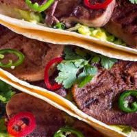 Steak Taco · Served with onion and cilantro on flour or corn tortilla.