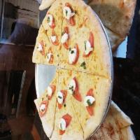 Caprese Pizza · Mozzarella, fresh sliced tomatoes, basil and oregano. Hand tossed brick oven baked thin-crus...