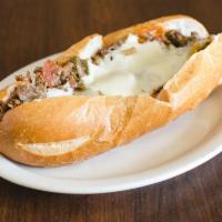 Signature Cheesesteak Sandwich · perfectly chopped steak, Fried onions, mushroom, green pepper, pepperoni, sausage topped wit...