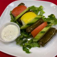 Stuffed Grape Leaves · Marinated grape leaves stuffed with rice, currants, pine nuts, onions and mediterranean spic...