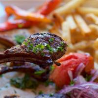 Lamb Chops · 4 baby lamb chops served with rice, grilled vegetables and pita bread.