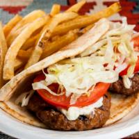 Greek Pita Burger · Wrapped in a pita with tomatoes, red onions, lettuce, and tzatziki sauce. Topped with feta.