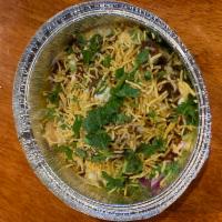 Samosa Chat · Cumin potatoes and peas mixed and garnished with yogurt, tamarind sauce, and mildly spiced c...