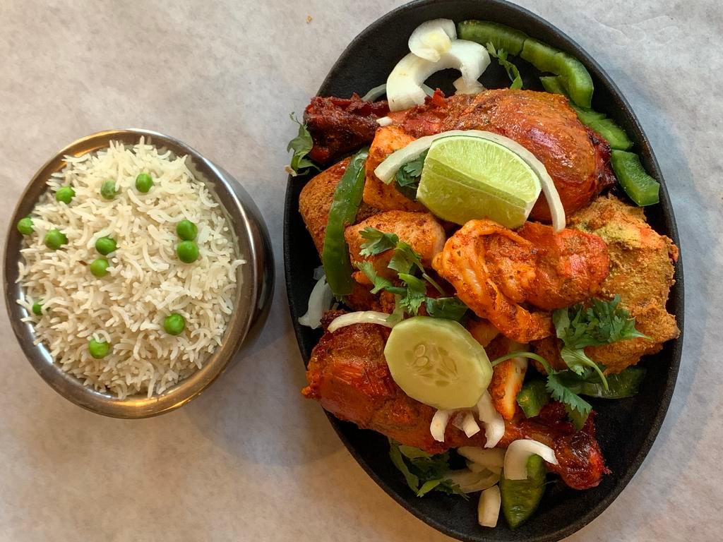 Tandoori Chicken · Chicken leg quarters marinated in yogurt, fresh spices, and lemon juice then barbecued in the clay oven.