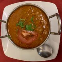 Goat Curry · Bone-in goat marinated and cooked in a curry sauce of fresh herbs and spices.